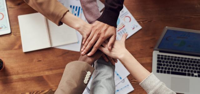 Top view image of businessman putting their hands together in the meeting